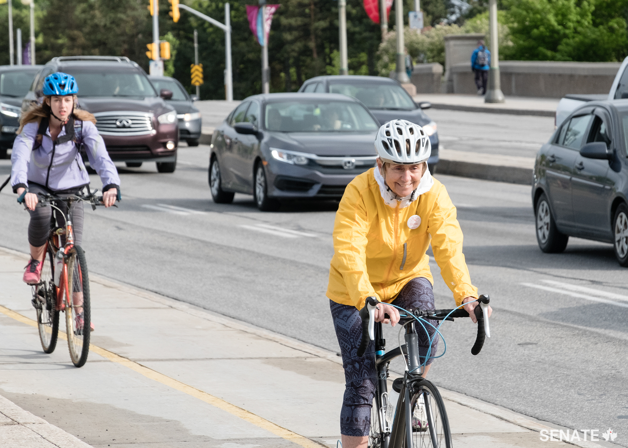 "National Health & Fitness Day is pleased to help connect Canadian cycling advocates with federal legislators for a discussion on the promotion of cycling.  Active transportation is an excellent way to increase overall physical activity of Canadians and help reduce traffic congestion,” says Senator Raine, seen here riding up the Portage Bridge over the Ottawa River en route to Gatineau, Quebec.