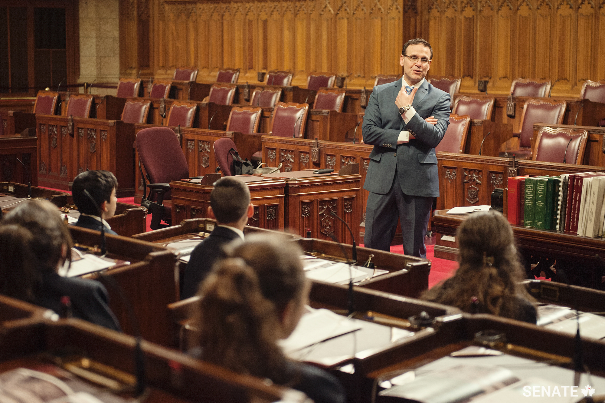 Senator Leo Housakos welcomes students to the Senate and explains some of the work that goes on in the chamber.