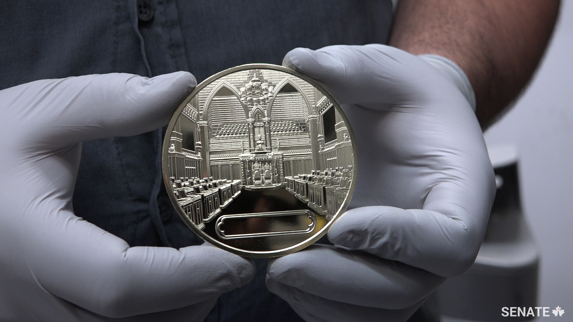The Senate Chamber and the medal recipient’s name will appear on the other side of the medal.