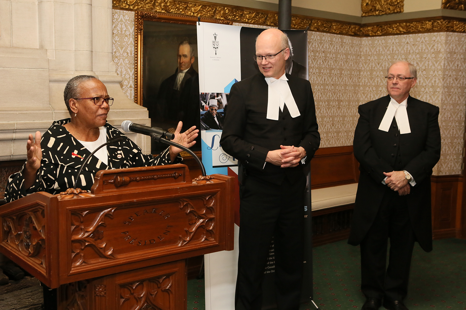Senator Wanda Thomas Bernard reads a poem composed by Parliamentary Poet Laureate George Elliott Clarke.