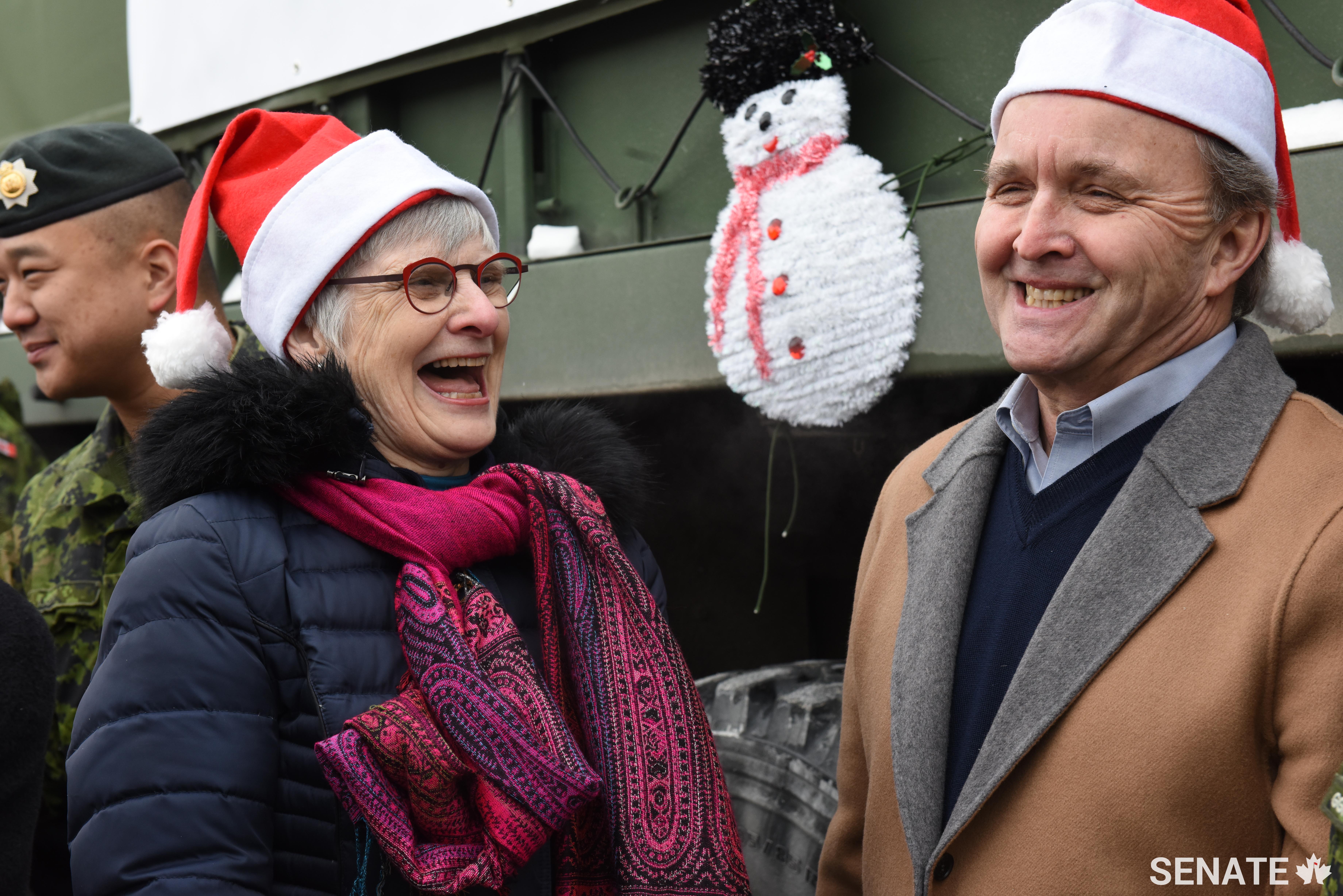 Senators Patricia Bovey and Grant Mitchell share a laugh during the Toys for Tots collection on Friday, December 15, 2017.