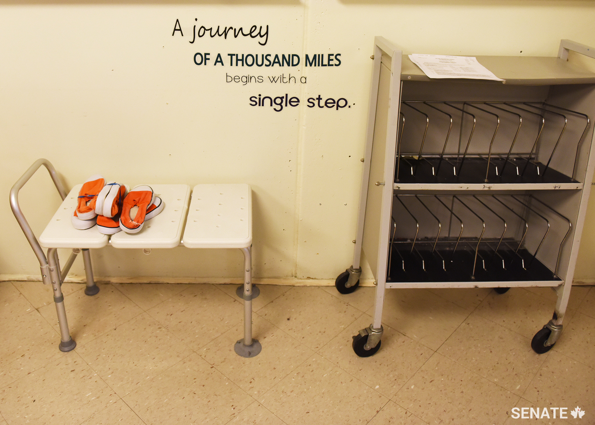 Standard-issue orange shoes await the start of their next journey.