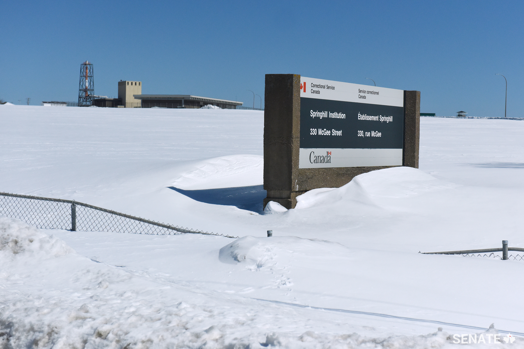 The Springhill Institution appears to be buried in snow when senators arrive on their fact-finding mission. Dark, concrete tunnels connect different buildings within the sprawling prison complex.