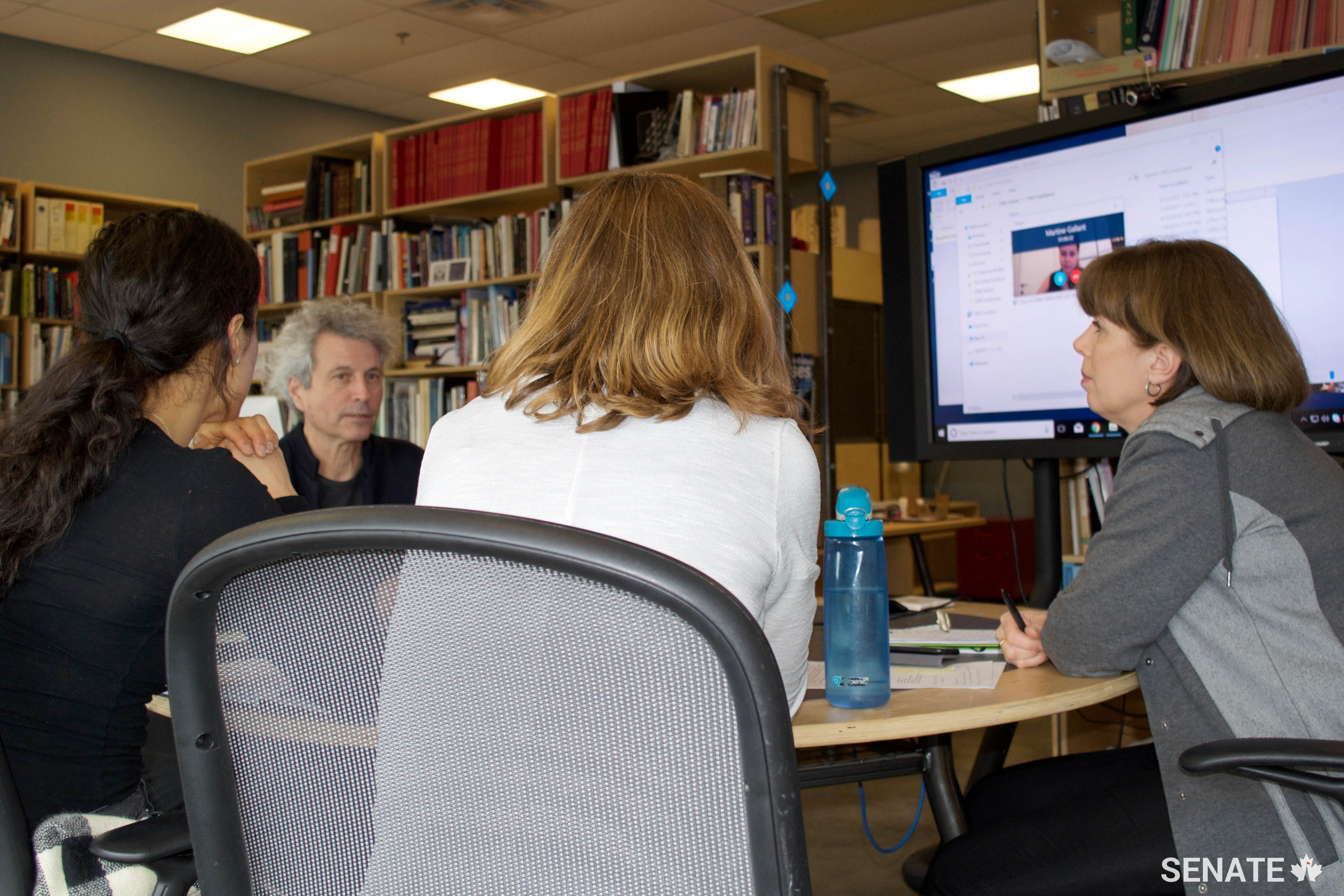 CIMS Director Stephen Fai (second from left) consults with his team, including (from left) Lara Chow, Katie Graham and operations manager Laurie Smith (right), about upcoming projects.
