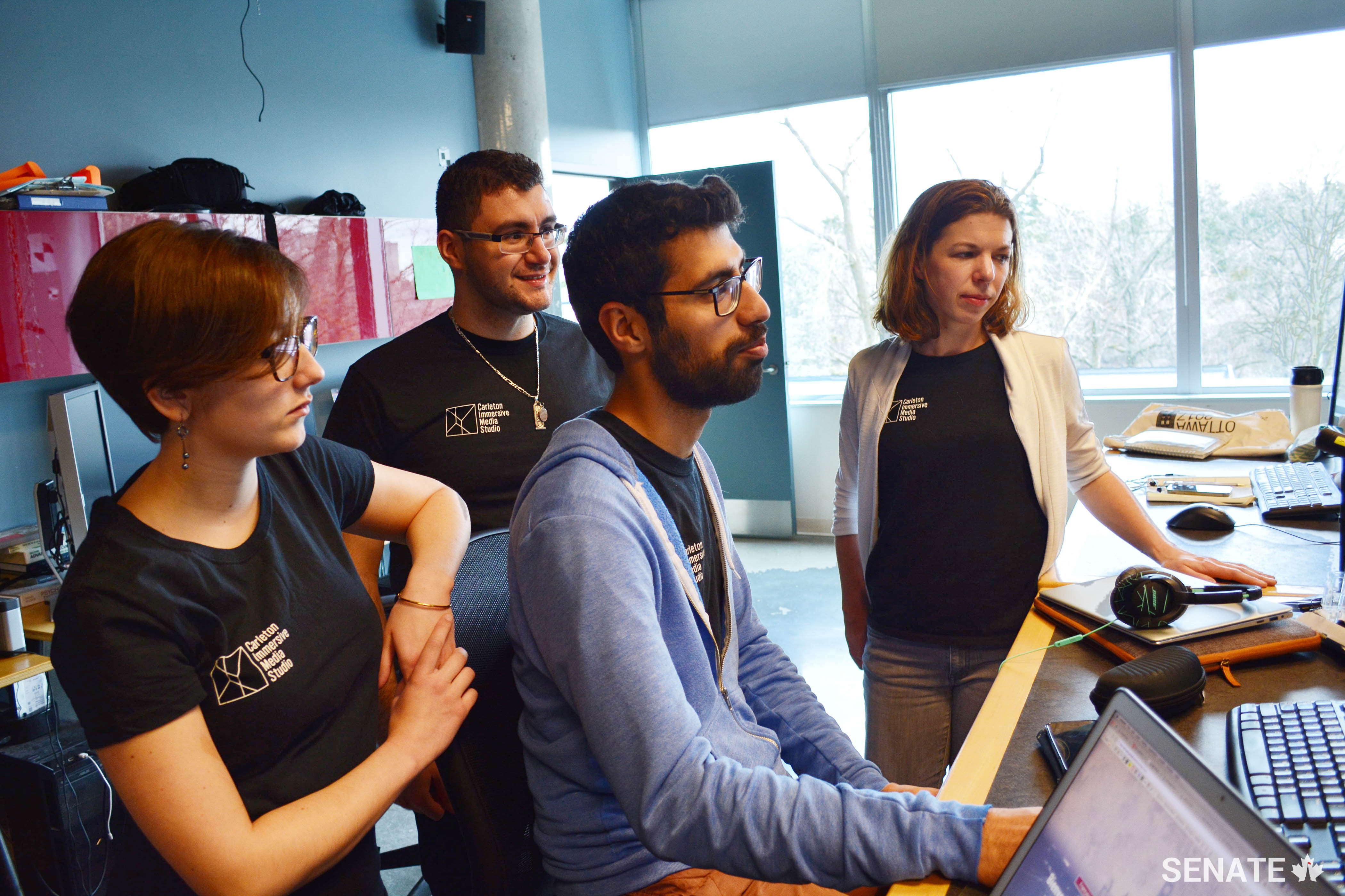 CIMS researchers (from left) Amanda Lapointe, Rufino Ansara, Abhijit Dhanda and Katie Graham evaluate the Senate Virtual Tour as the project nears completion.