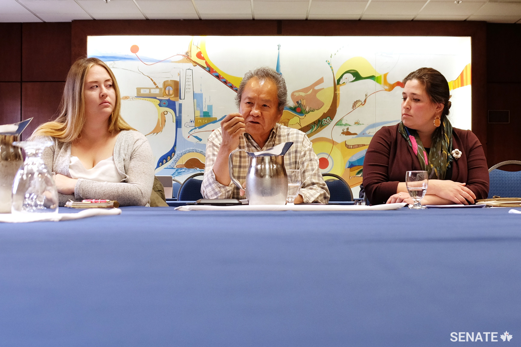 From left, Dechinta Centre for Research and Learning alumna Jasmine Vogt, elder and professor Samual Gargan, and Dechinta’s policy and programming director Kelsey R. Wrightson speak with senators about the school’s culturally relevant, land-based programming for Indigenous students in Yellowknife, N.W.T. The group’s federal funding was cut this year due to changes to the Post-Secondary Student Support Program. They said the precarious funding situation makes it difficult for students to plan for their future.