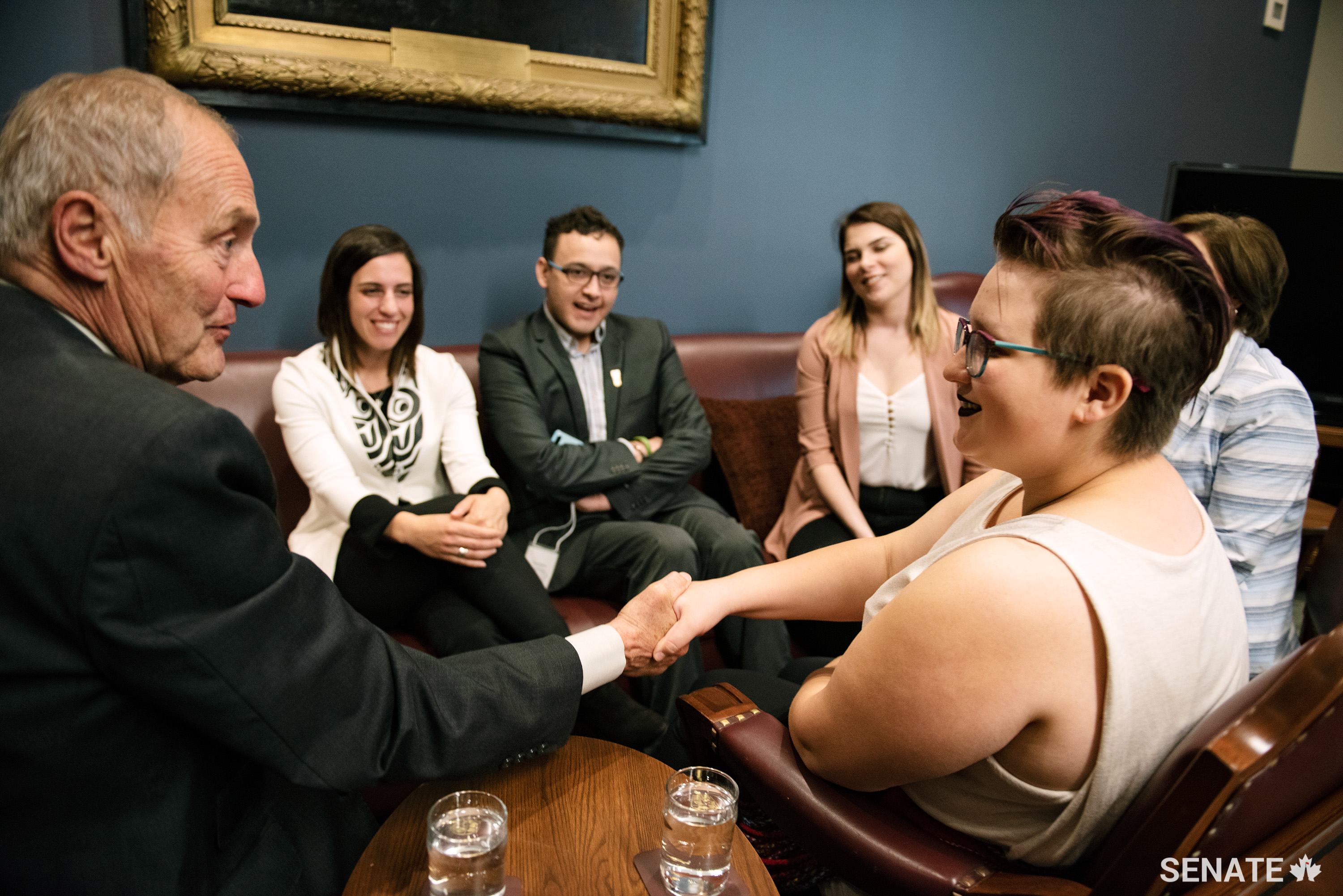 Senator Joseph A. Day shakes hands with Aurora Leddy, 22, a Métis woman from Alberta, during a group discussion with other Indigenous youth on June 5, 2019. Youth Indigenize the Senate participants met privately with senators Joseph A. Day, Peter Harder, Diane Bellemare and Margaret Dawn Anderson to discuss issues affecting Indigenous communities in Canada.