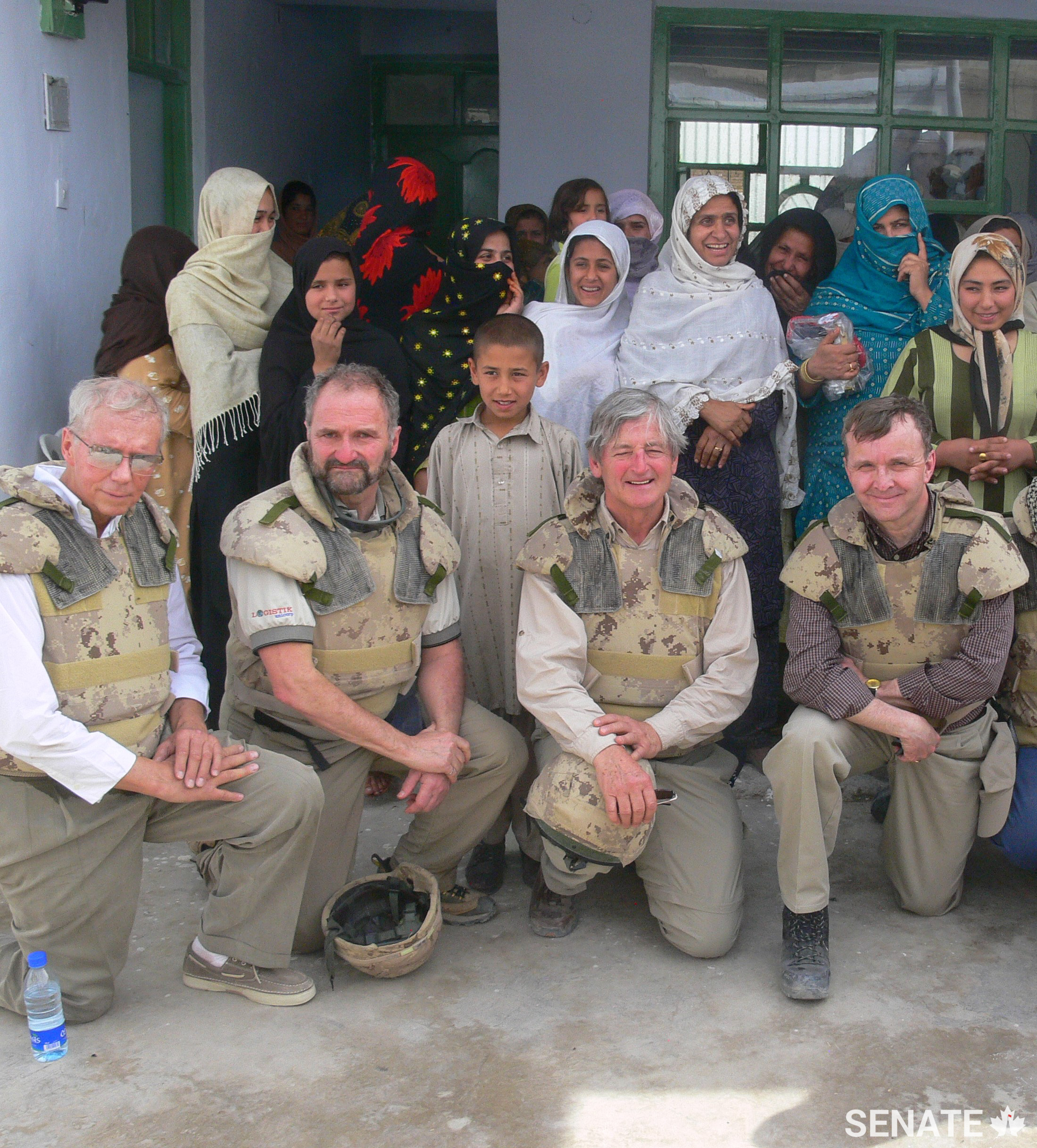 Senator Grant Mitchell, right, meets participants at a women’s vocational program in Afghanistan with other members of the Senate’s defence committee.