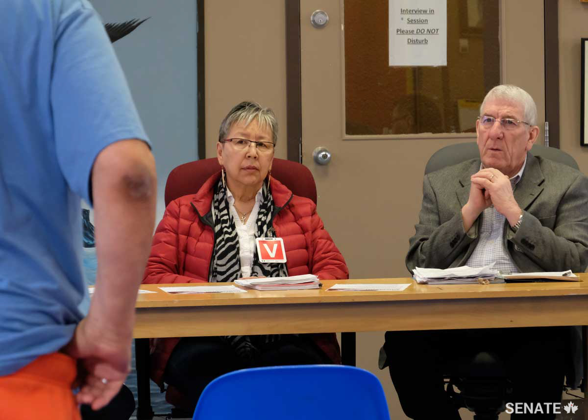 An Indigenous inmate at the Saskatchewan Penitentiary in Prince Albert tells senators Lillian Eva Dyck and Norman E. Doyle about the challenges he faces within the federal prison system during a Senate Committee on Aboriginal Peoples fact-finding mission in March 2018.