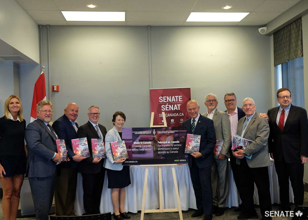 Senator Doyle, second from right, helps launch the Senate Committee on Agriculture and Forestry report, <em>Made in Canada: Growing Canada’s Value-Added Food Sector</em>, in 2019 with fellow committee members in Charlottetown, P.E.I.