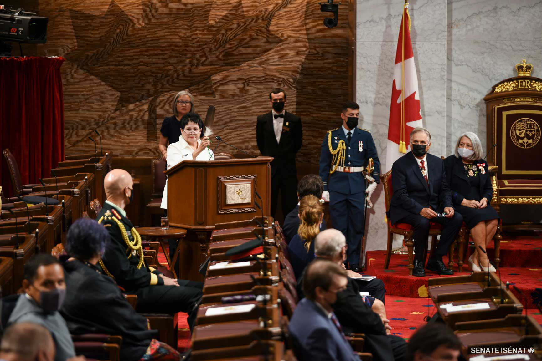 Governor General Mary Simon and her spouse Whit Fraser look on as Claudette Commanda, an Algonquin elder, welcomes guests at the installation ceremony.