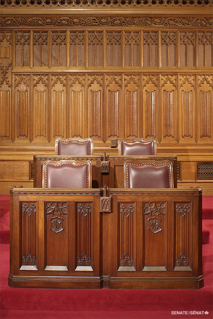 Senators’ desks pictured in Centre Block’s Senate Chamber shortly before the building was closed for rehabilitation. Front-row desks are decorated with botanical emblems.