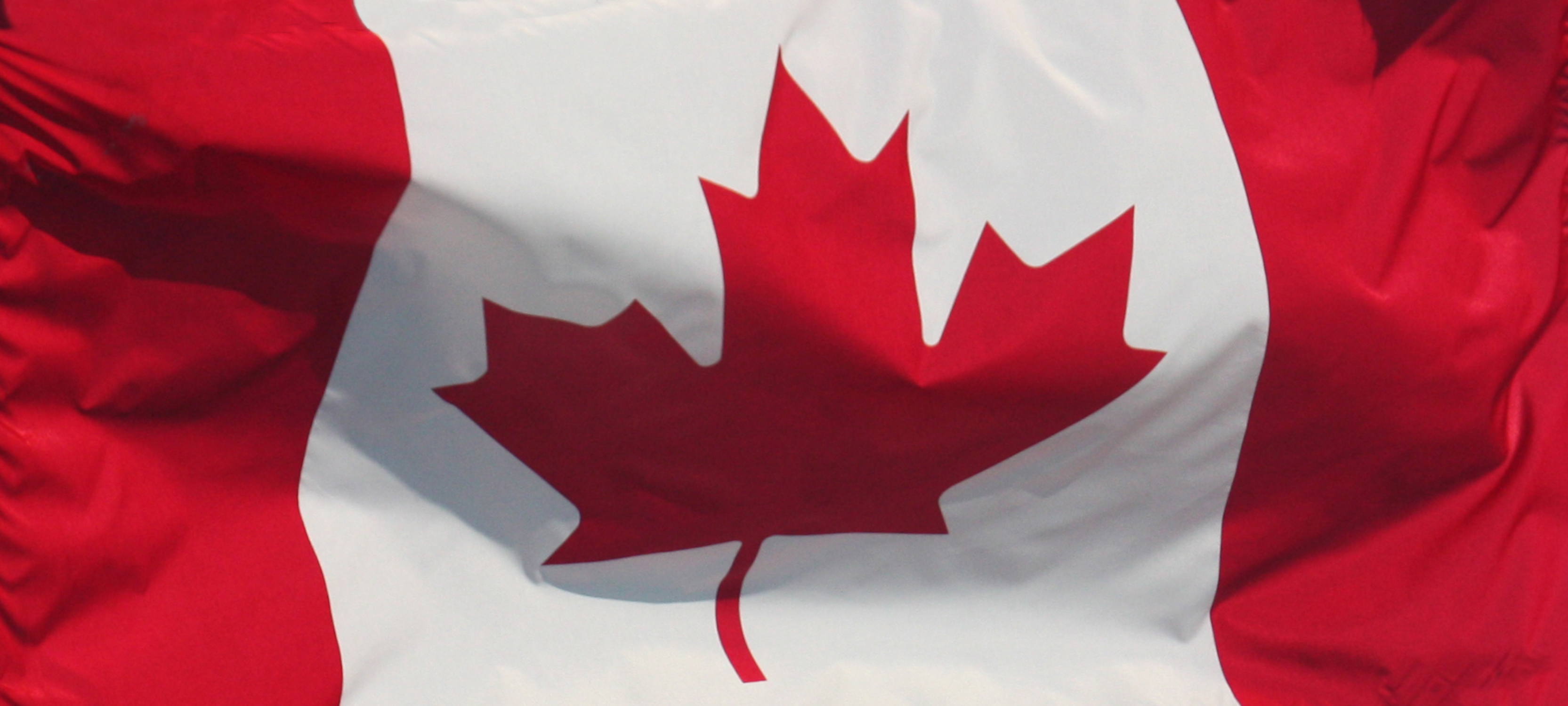 The Canadian flag billowing in the wind